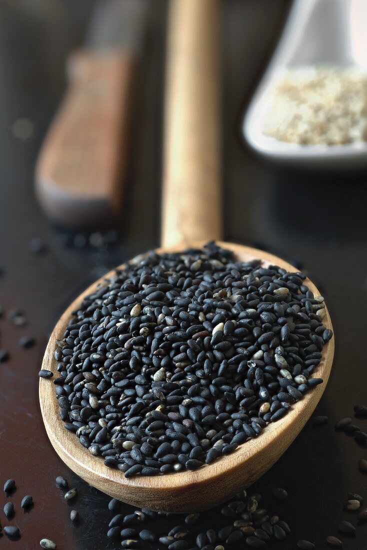 Black sesame seed in an olive wood spoon