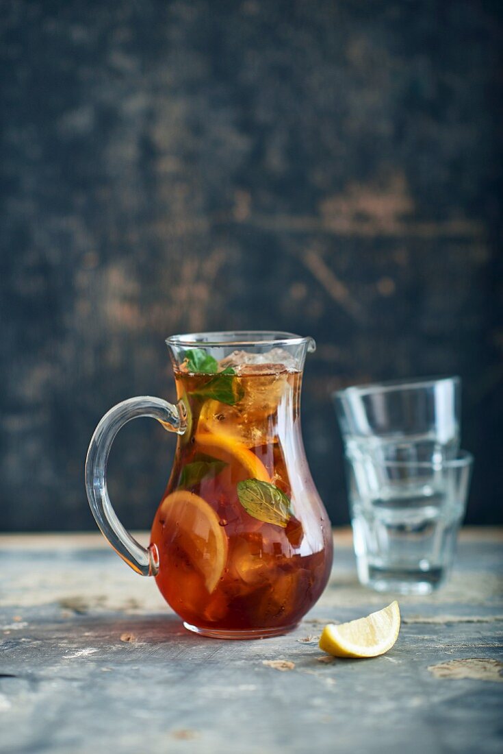 Punch in a glass jug on a wooden table