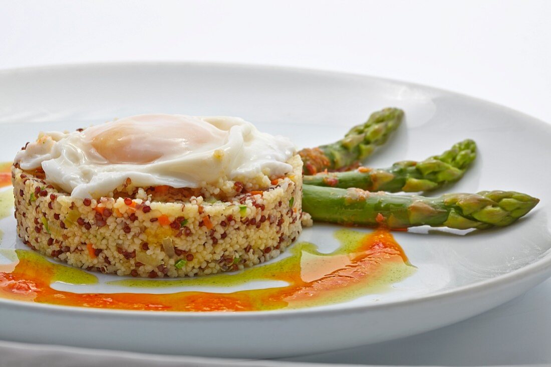 Quinoa timbale with fried egg and green asparagus