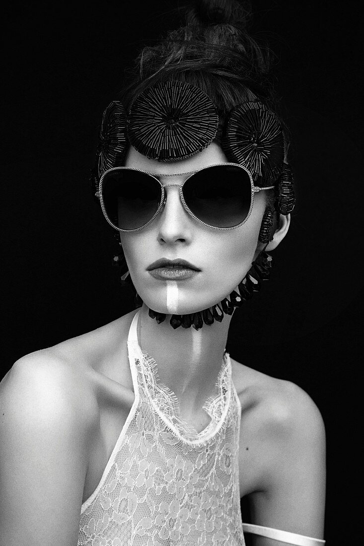 A young woman wearing a lace top and a sequinned cap (black-and-white shot)