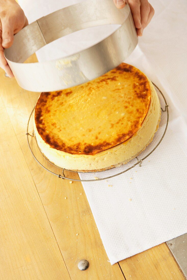 A ring being removed from a cheesecake