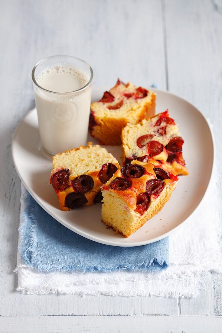 Yeast cake with plums served with a glass of soya milk