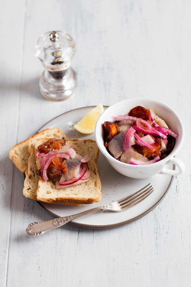 Herring pickled in vinegar with plums and red onions