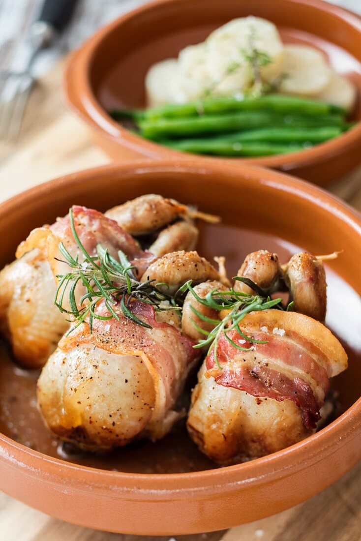 Quails wrapped in bacon