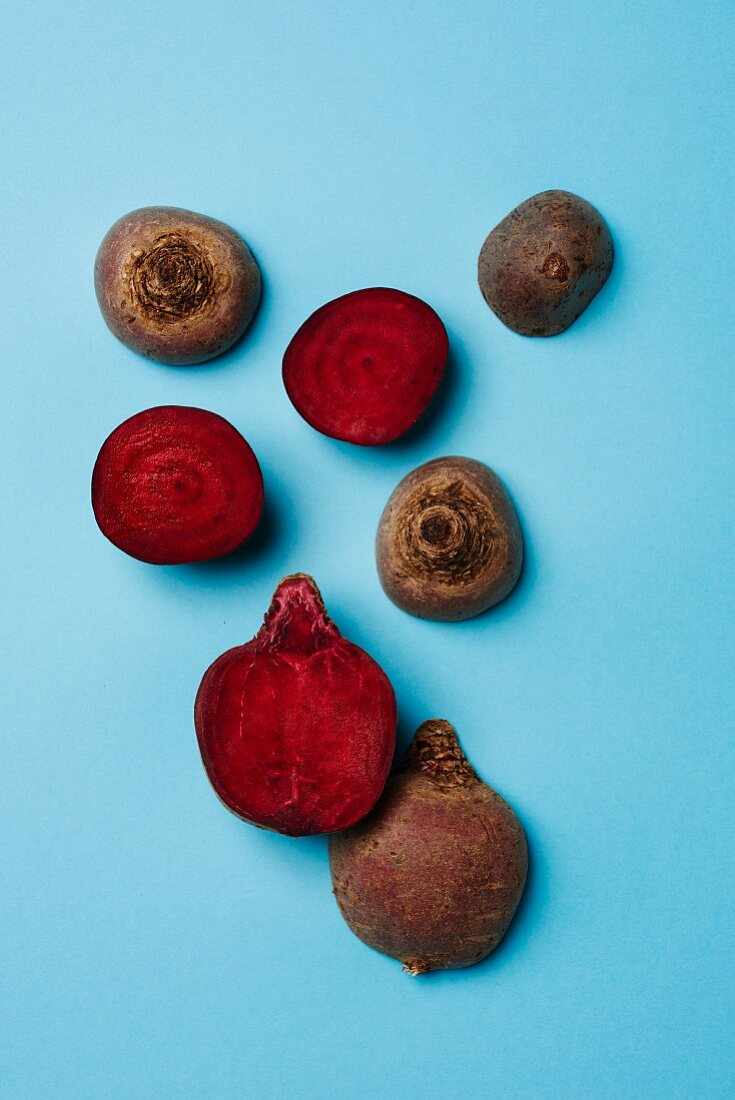 Beetroot on a blue surface, partially halved