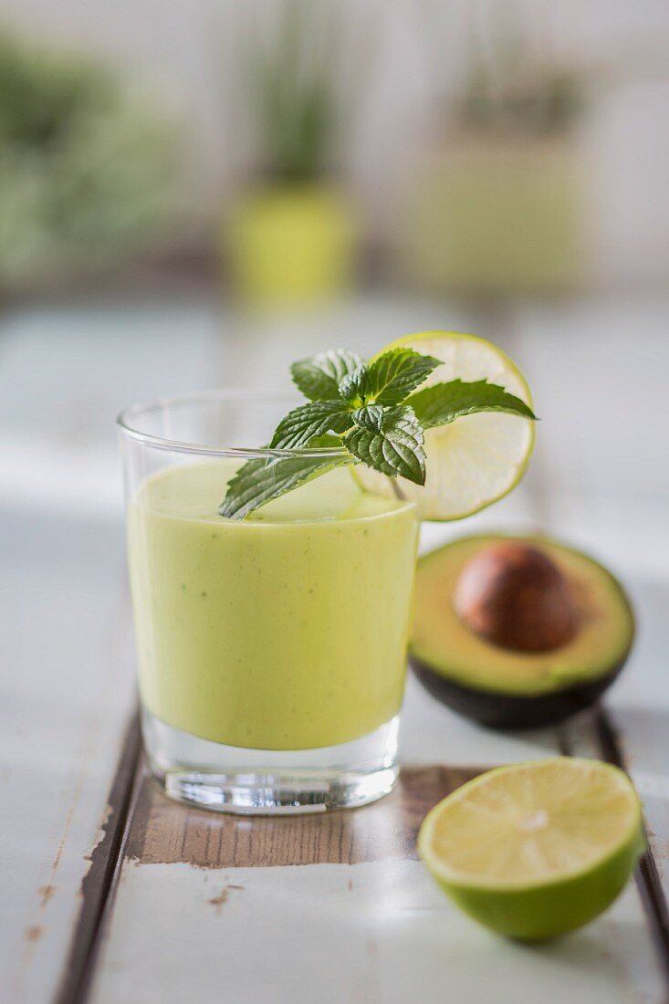 An avocado drink with limes and mint