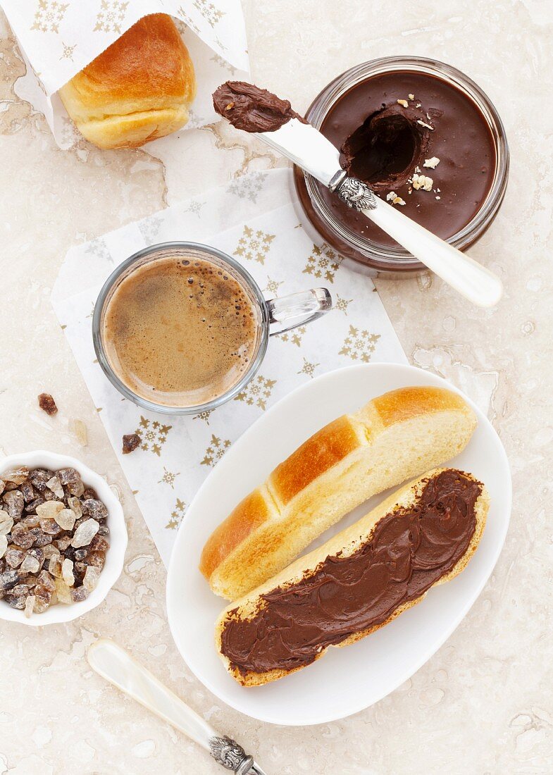 A toasted brioche roll with chocolate spread served with coffee