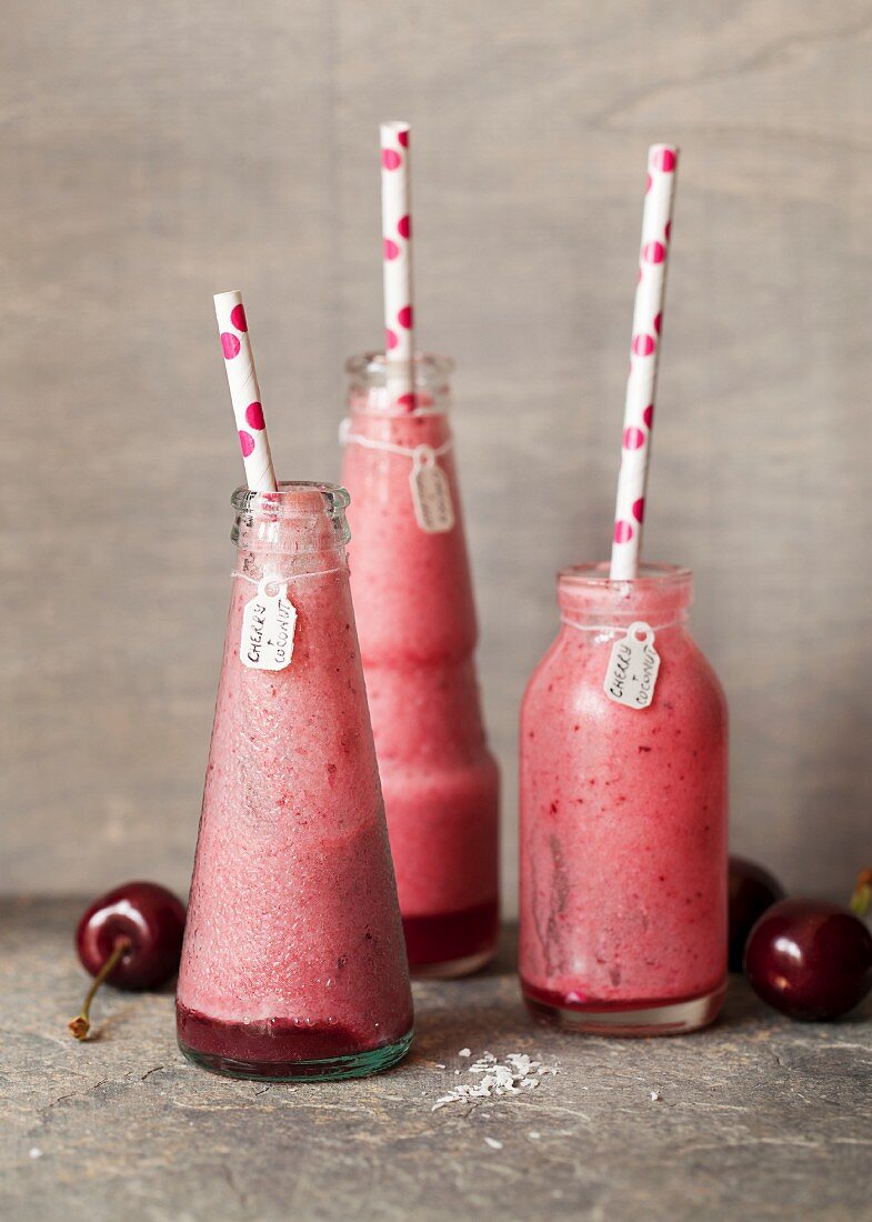 Half-drunk cherry and coconut smoothies
