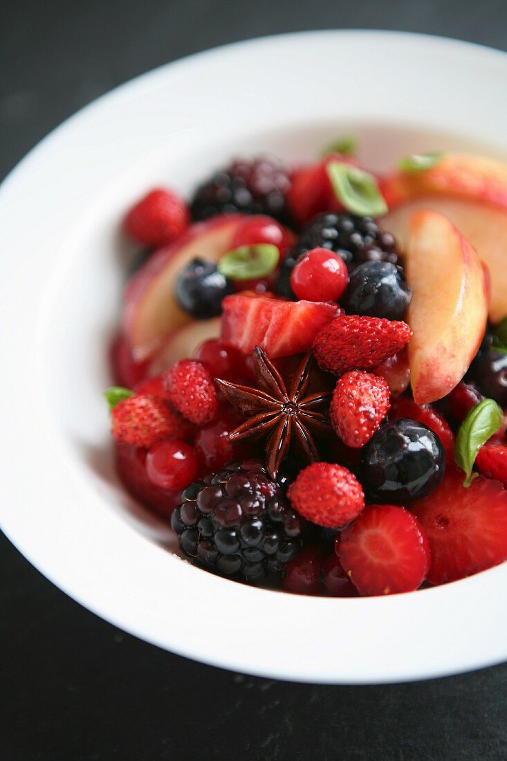 Summer fruit salad with star anise and wild strawberries