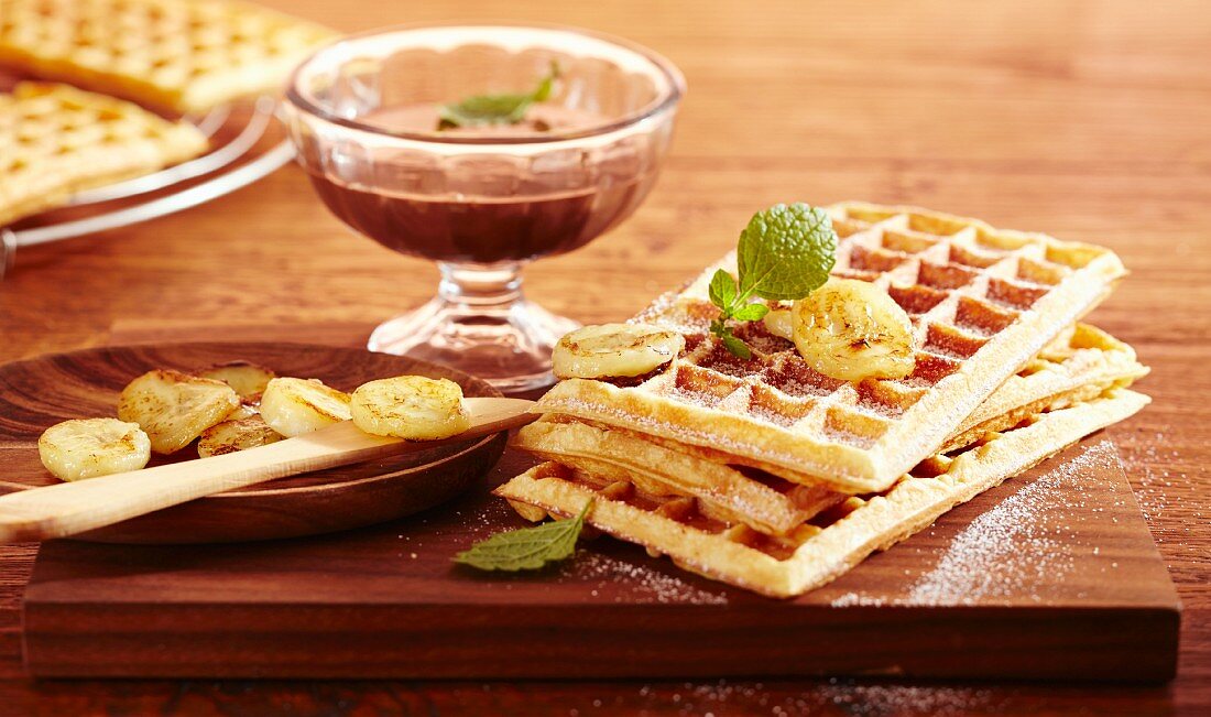 Brussels waffles with fried bananas and chocolate and rum sauce