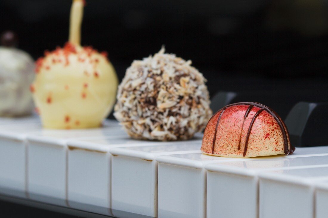 Various pralines on the keys of a piano