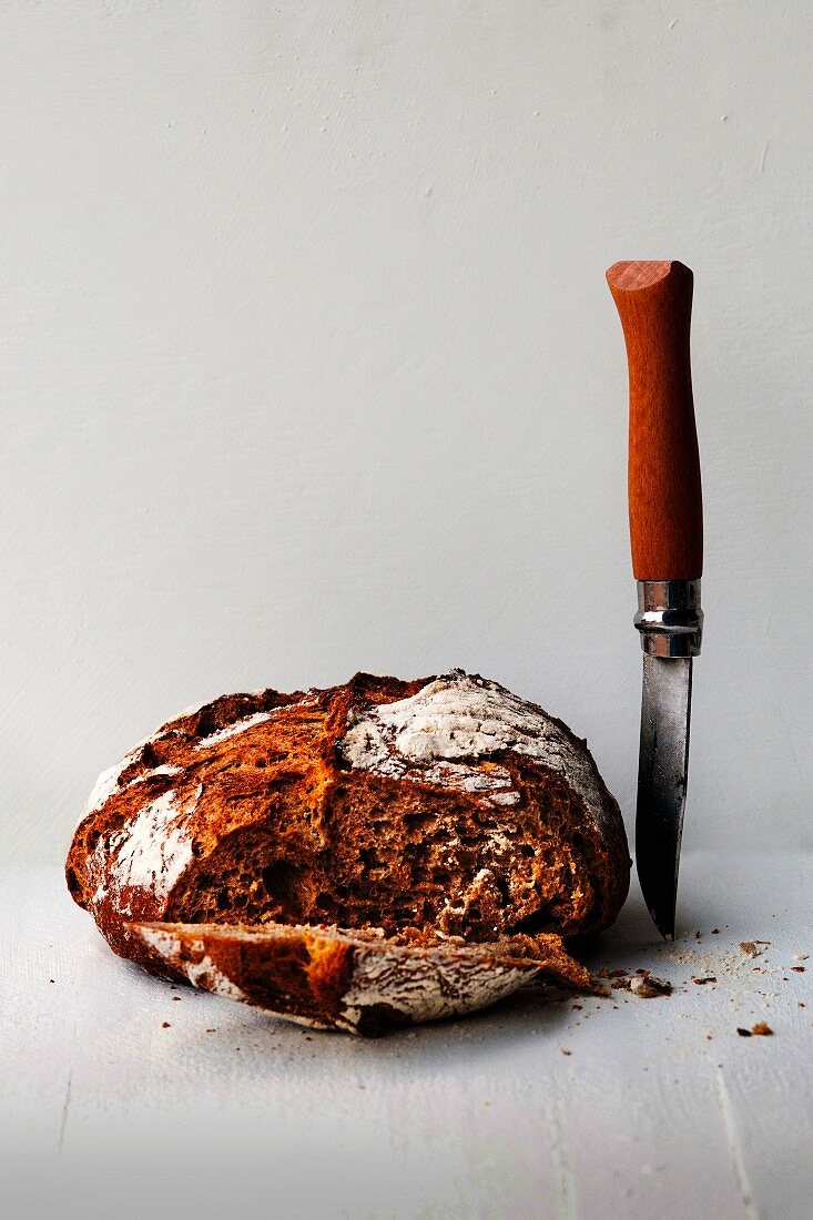 A rustic loaf of bread, sliced