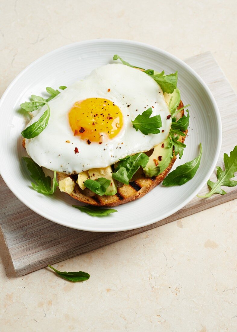 A fried egg and avocado on toast