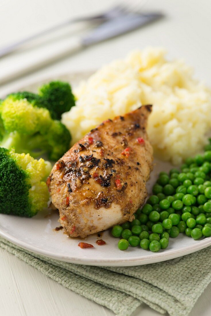 Lemon and garlic chicken with broccoli, peas and mashed potatoes