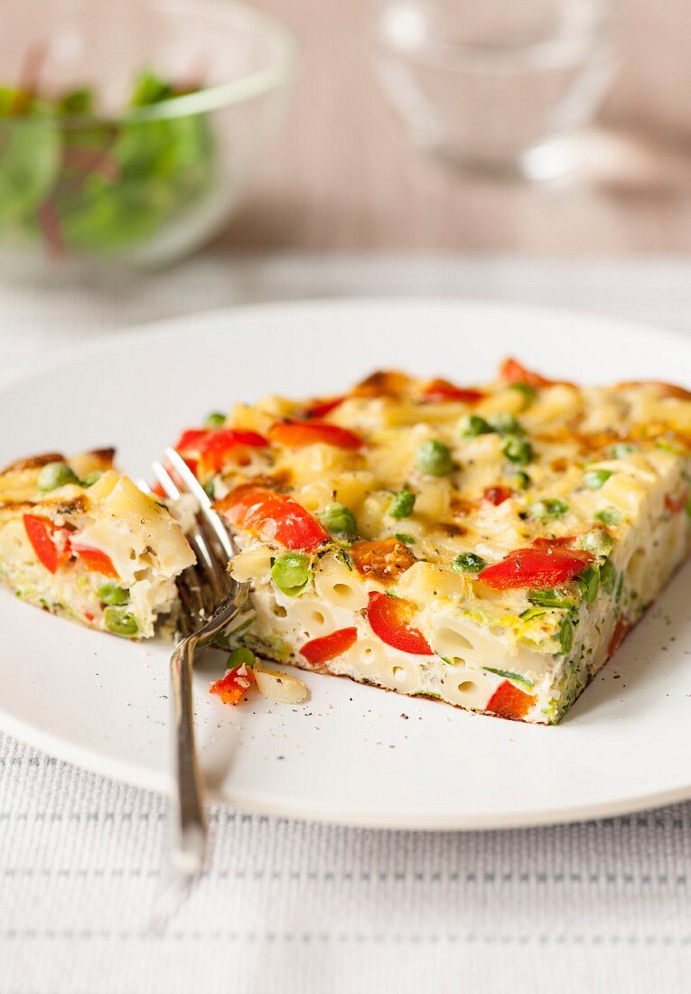 A portion of macaroni and vegetable quiche