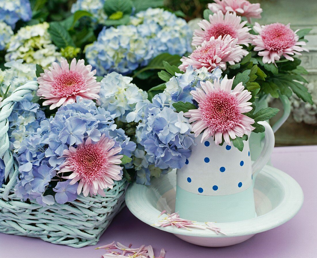 Pink chrysanthemums and blue hydrangeas arranged in retro jug