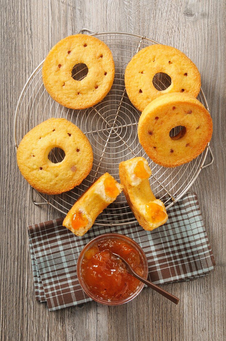 Ring-shaped cakes with jam on a cooling rack