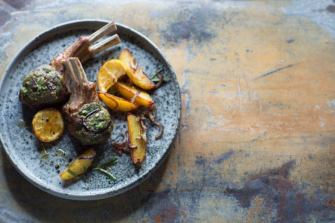 Lamb chops with herbs, lemons and potato wedges