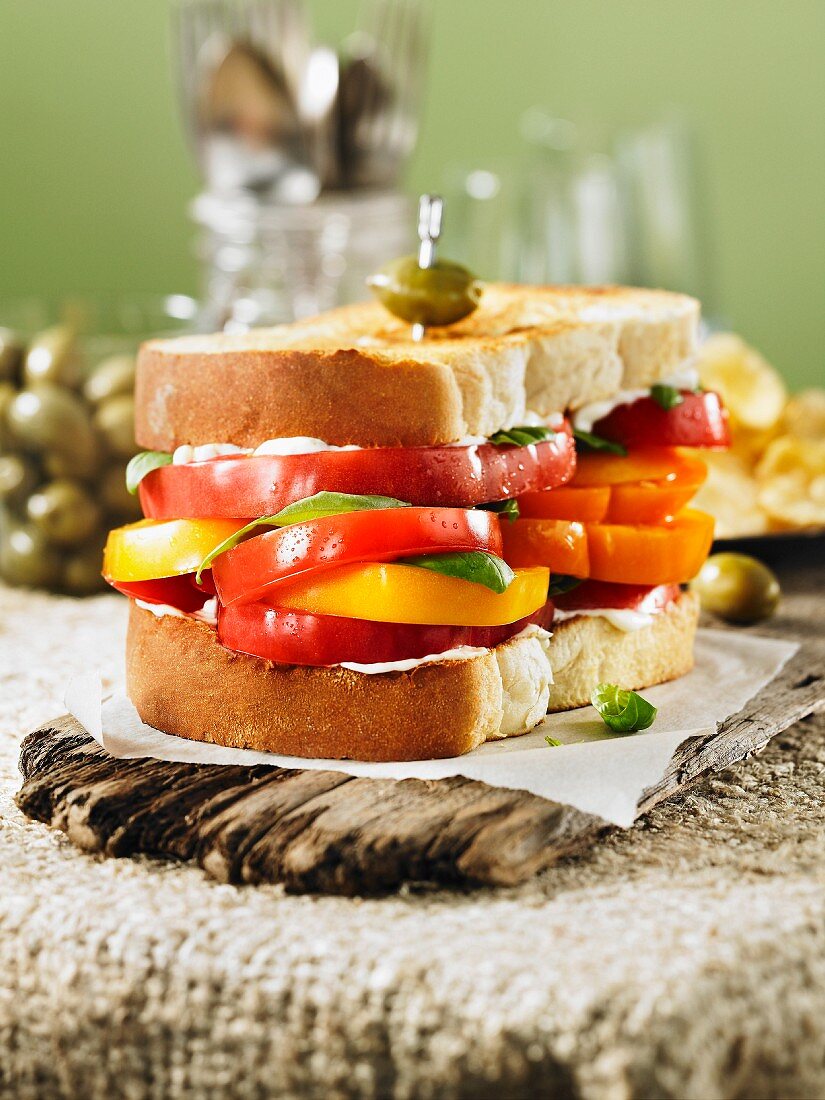 A giant sandwich with red and yellow tomatoes