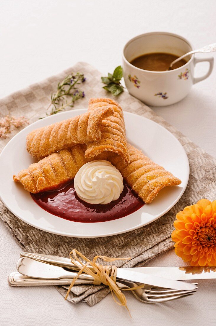 Spagatkrapfen (deep-fried crispy wafers from Austria) with damson mousse and whipped cream