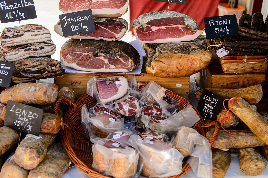 Various types of ham at a market in Ajaccio (Corsica)