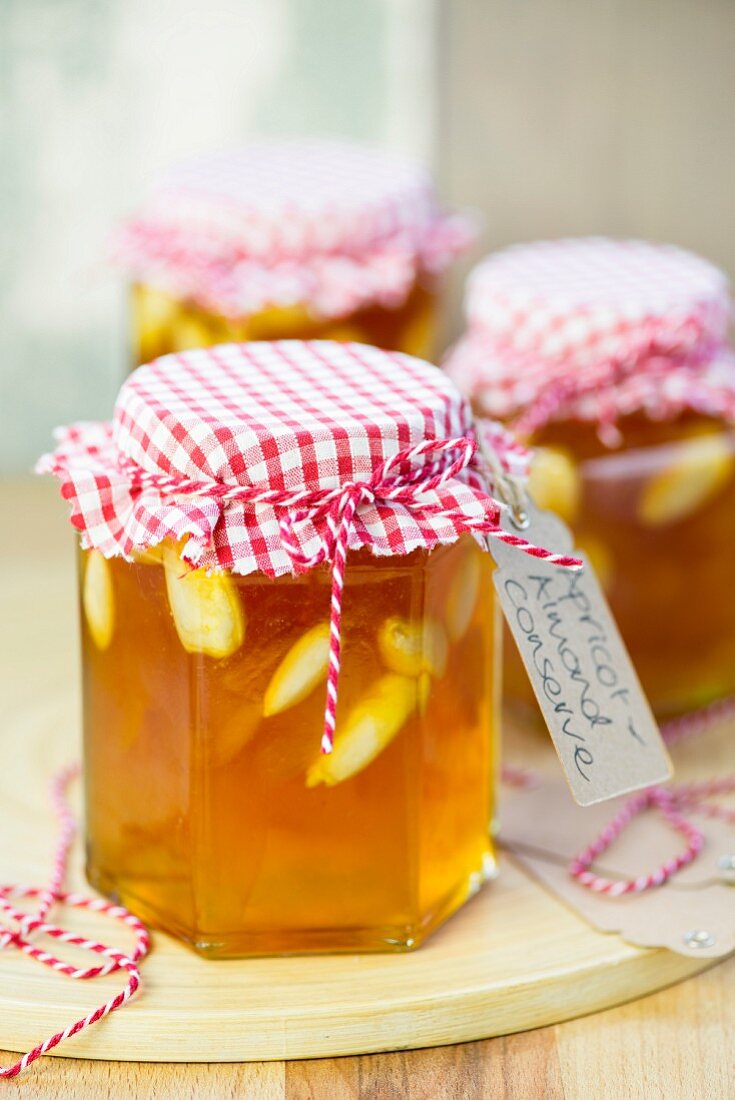 Jars of apricot jam with whole almonds