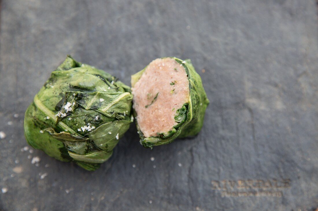 A sausage meatball wrapped in cabbage