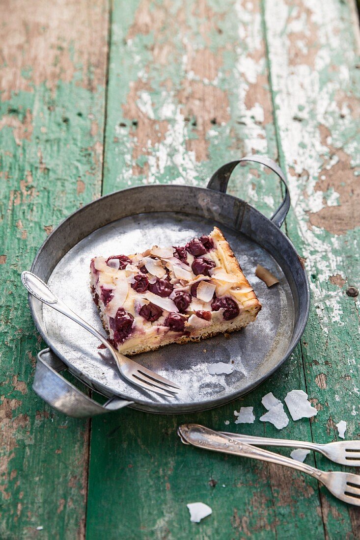 A slice of mascarpone and cherry cake