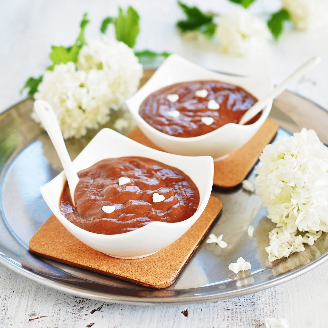 Two bowls of chocolate pudding with white sugar hearts