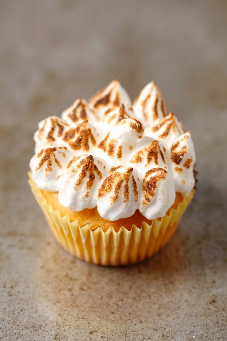 A lemon cupcake with a meringue topping
