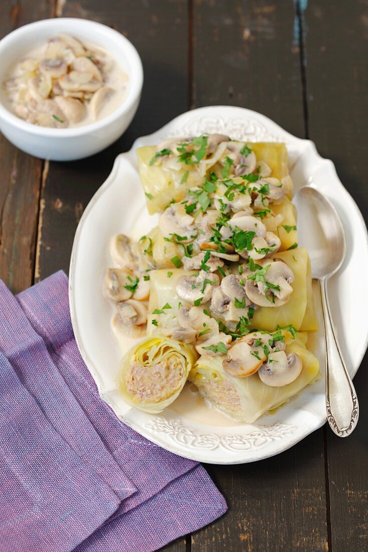 Cabbage roulade filled with minced chicken and lentils served with a mushroom sauce