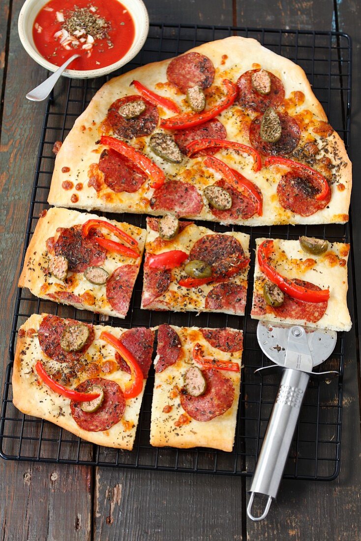 A salami, pepper and caper pizza
