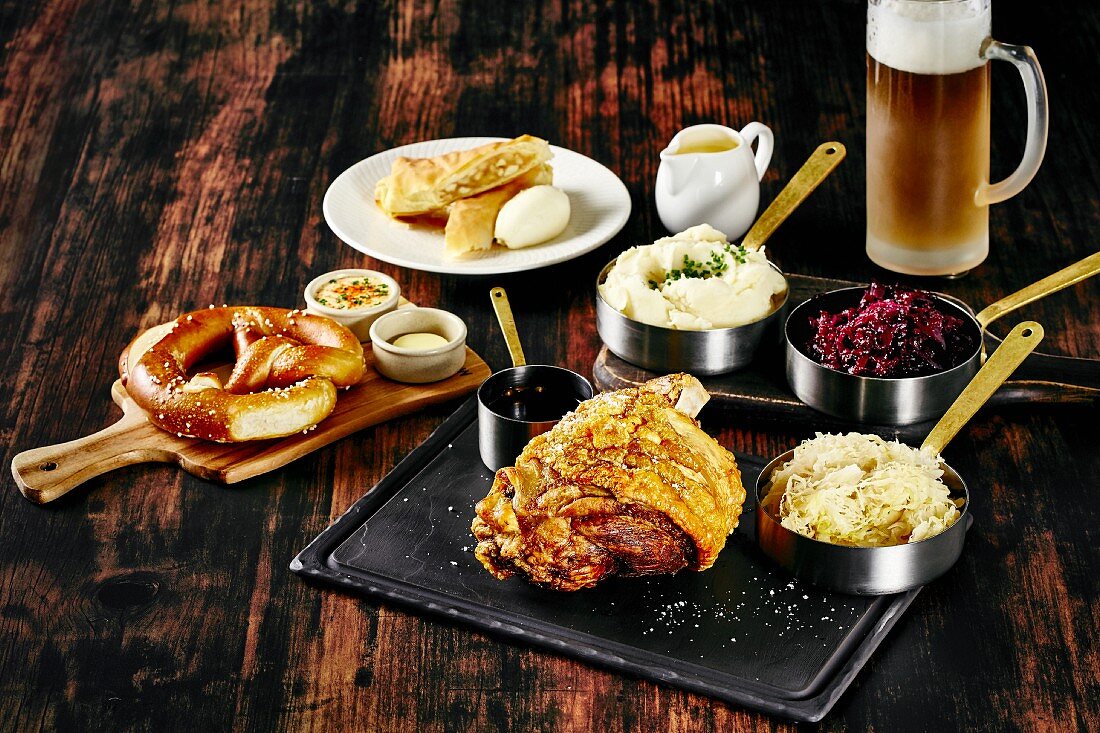 Oktober Fest food: pretzel, pork knuckle with side dishes and beer