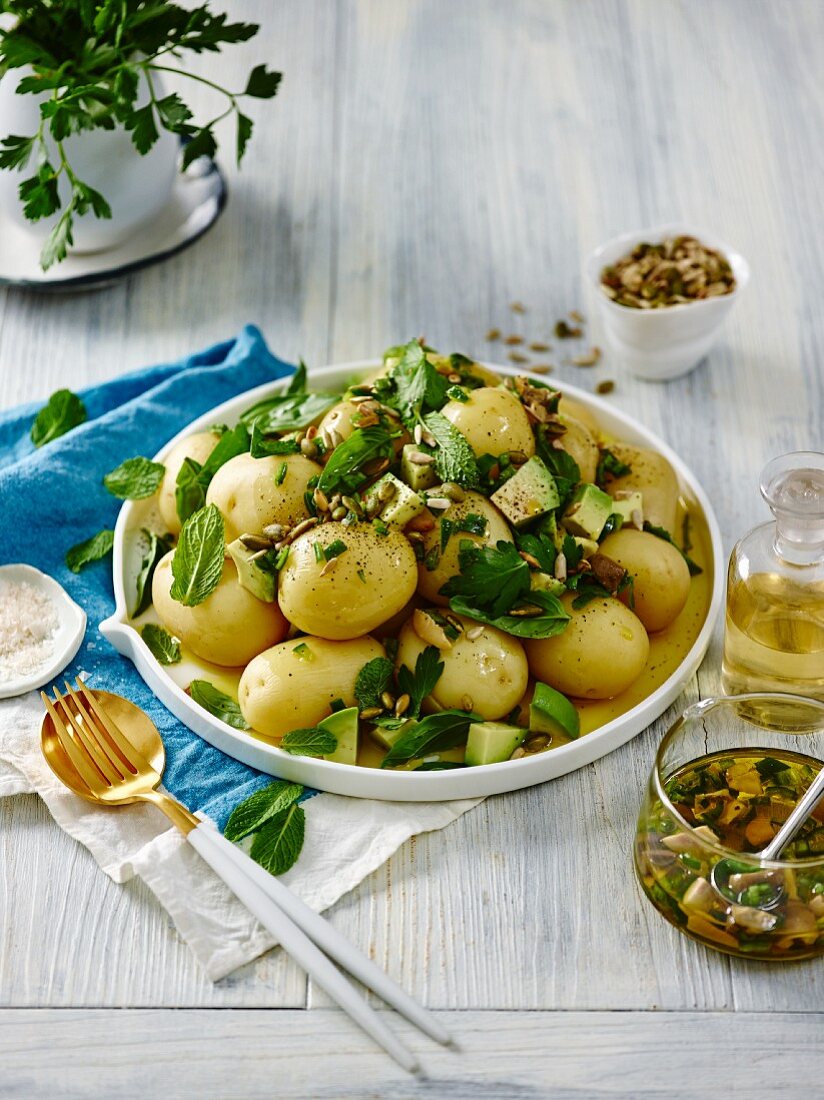 Potato salad with new potatoes, avocado, herbs and seeds