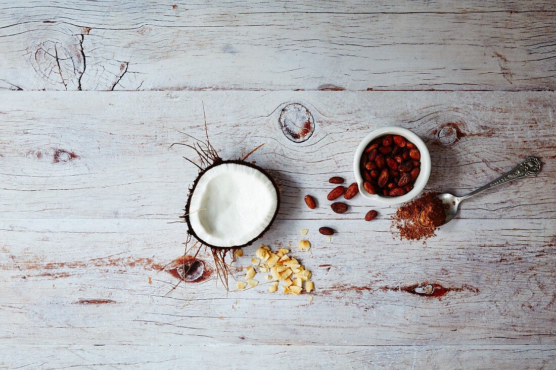 Superfood: coconut, cocoa and goji berries on a wooden surface (seen from above)