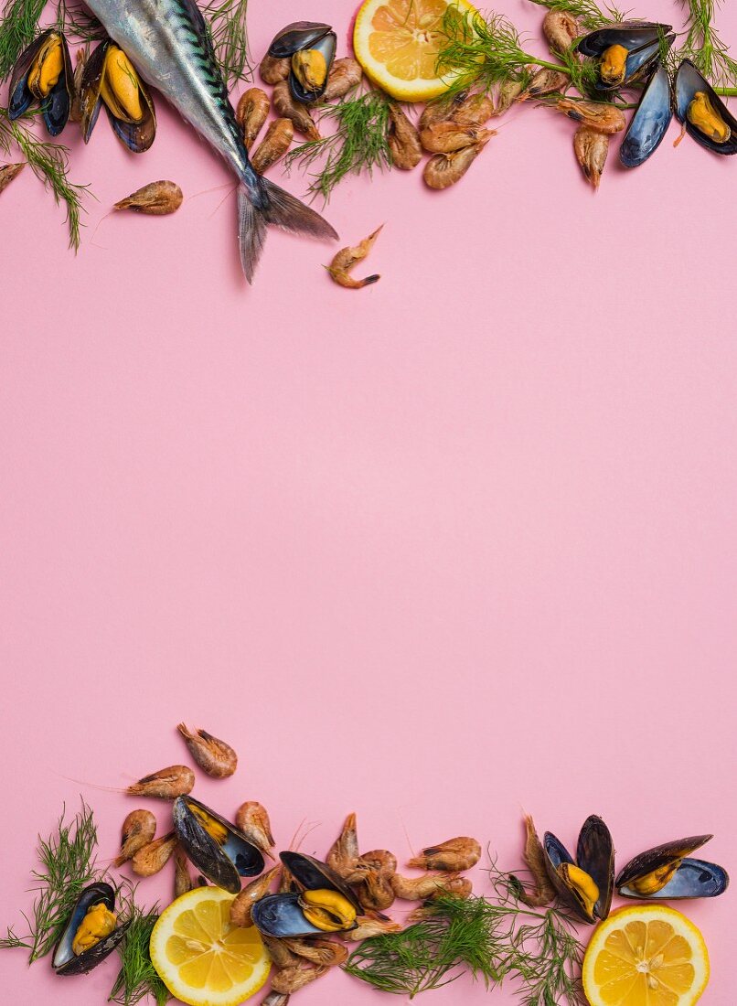 An arrangement of mussels and shrimps on a pink surface