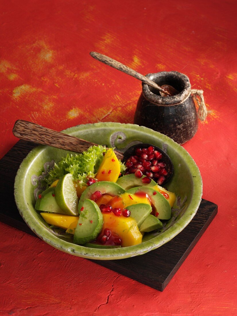Mango and avocado salad with spicy pomegranate seed dressing