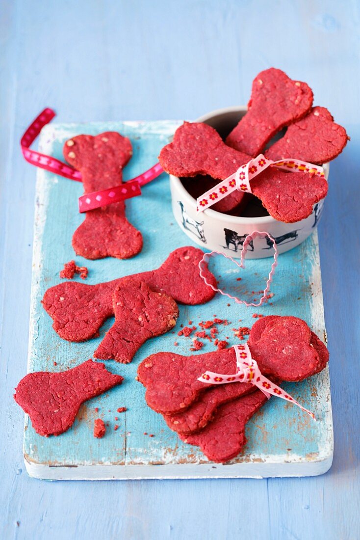 Treats for a dog - bone shape biscuits made with beetroot juice, oats and wholemeal flour