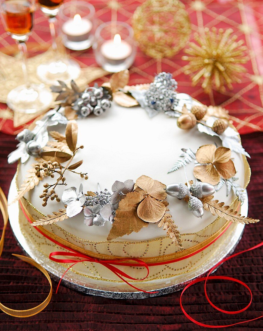 Christmas cake decorated with painted leaves
