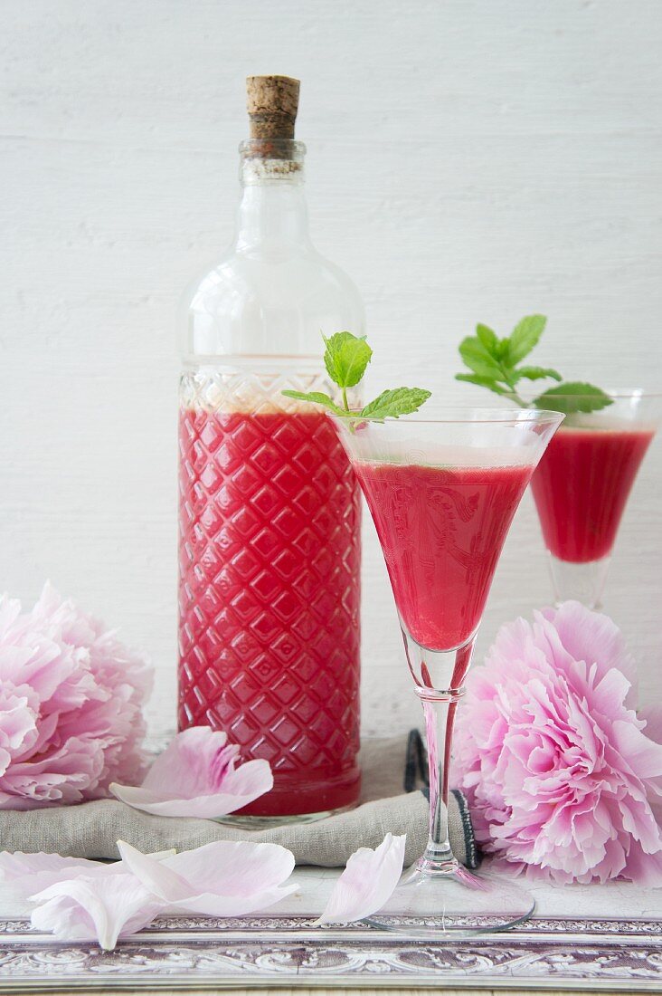 Home-made raspberry liqueur with spring roses