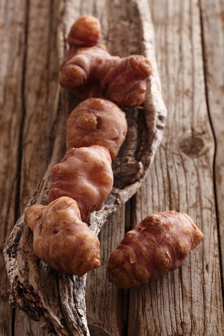 Jerusalem artichokes on wooden background