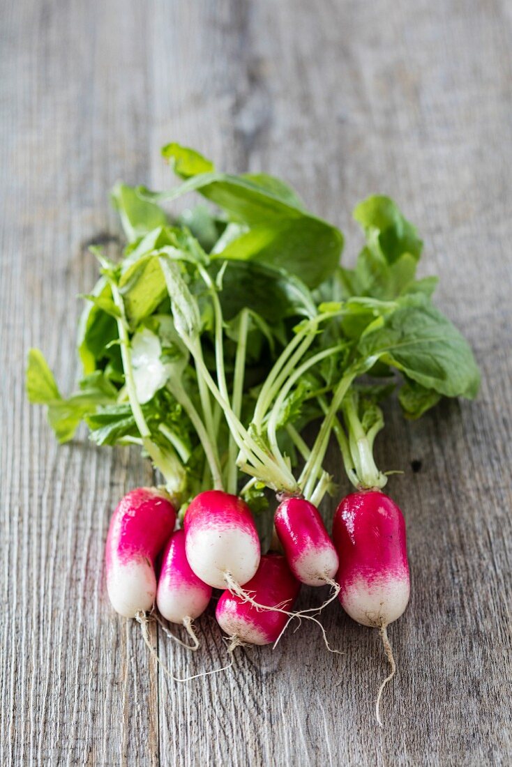 Fresh white spot radishes on a wooden surface