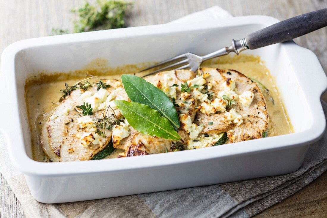 Gratinated turkey escalope with courgette, feta cheese and herbs