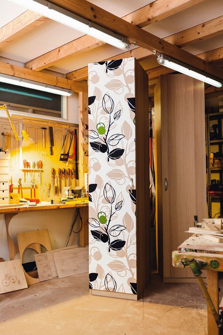 Cupboard with fabric covered door in workshop