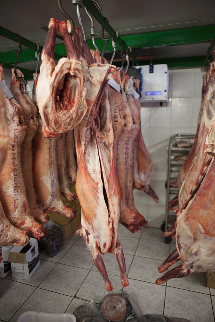 Lamb carcasses hanging in a butcher's