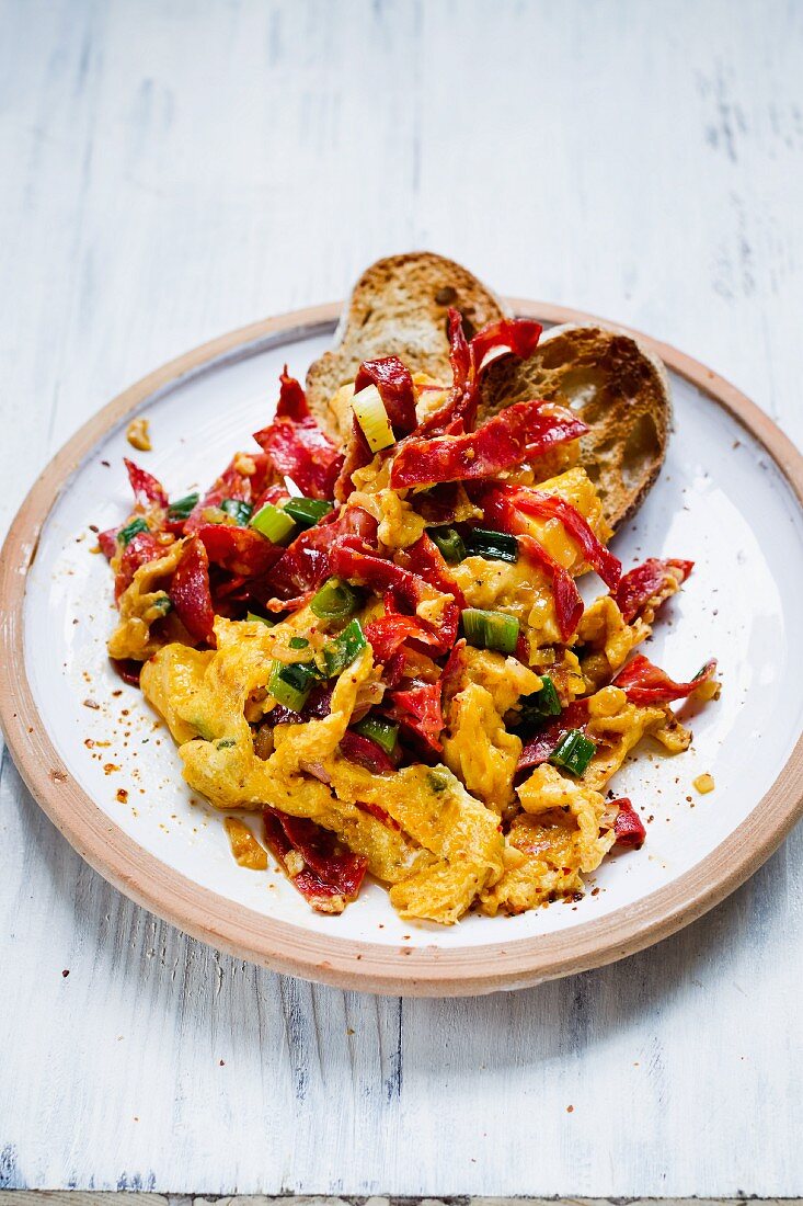 Spoonfuls of scrambled eggs with diced chorizo