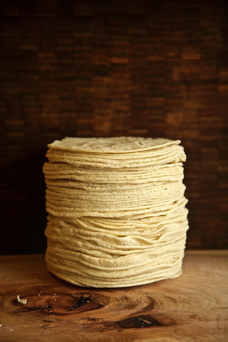 A stack of tortillas on a wooden table