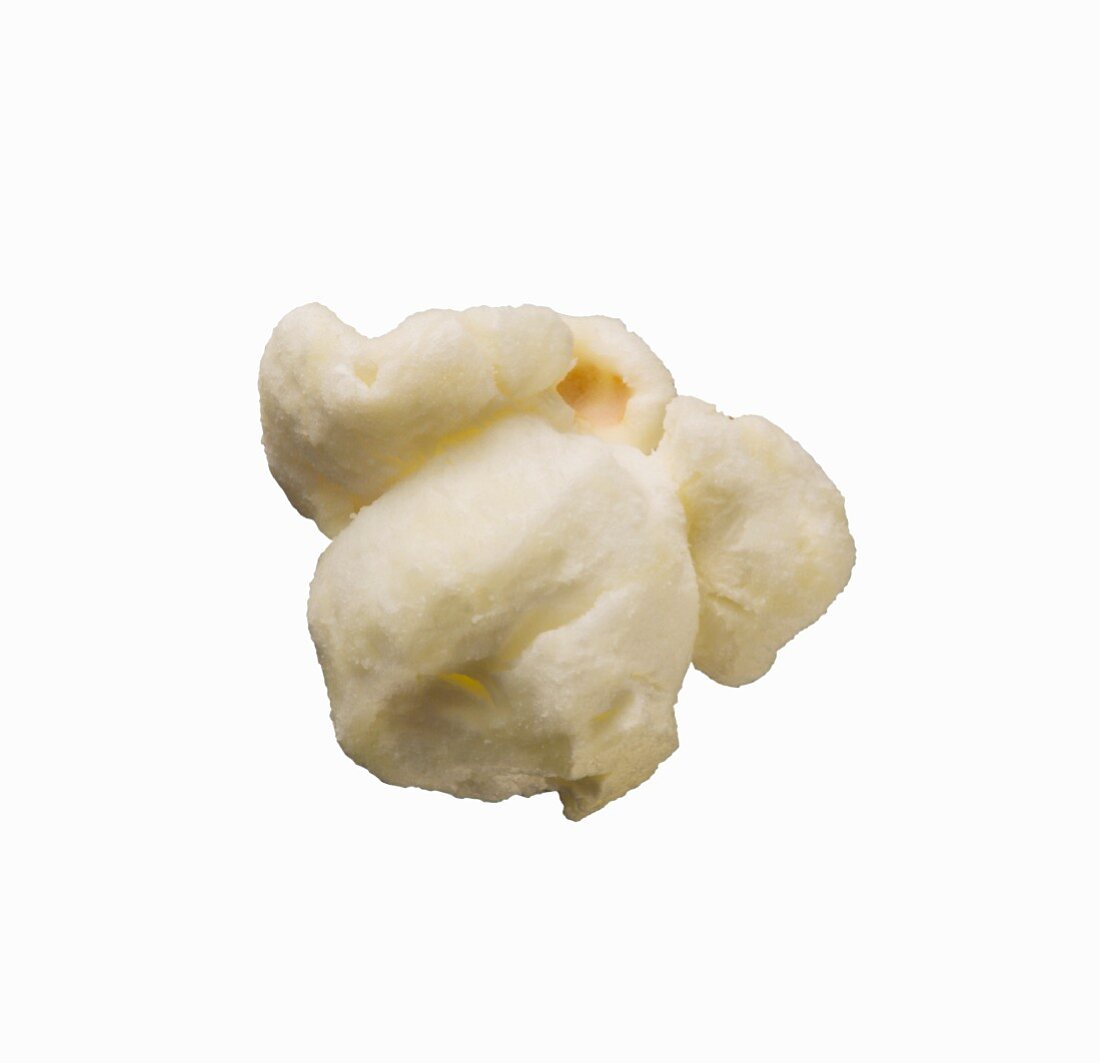 A piece of popcorn on a white surface (close-up)