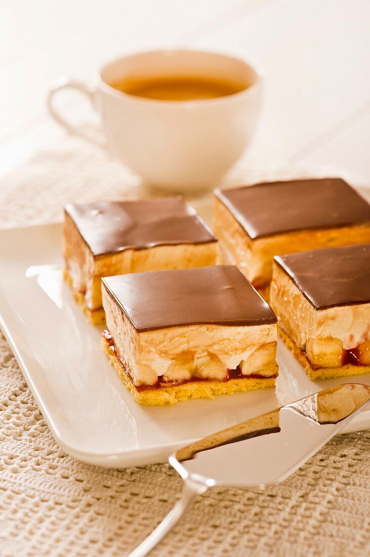 Banana slices on a plate with a cake slice