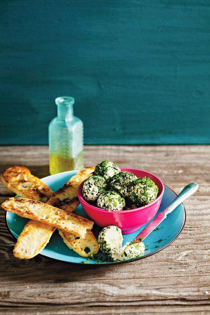 Cream cheese balls with winter herbs and toasted bread